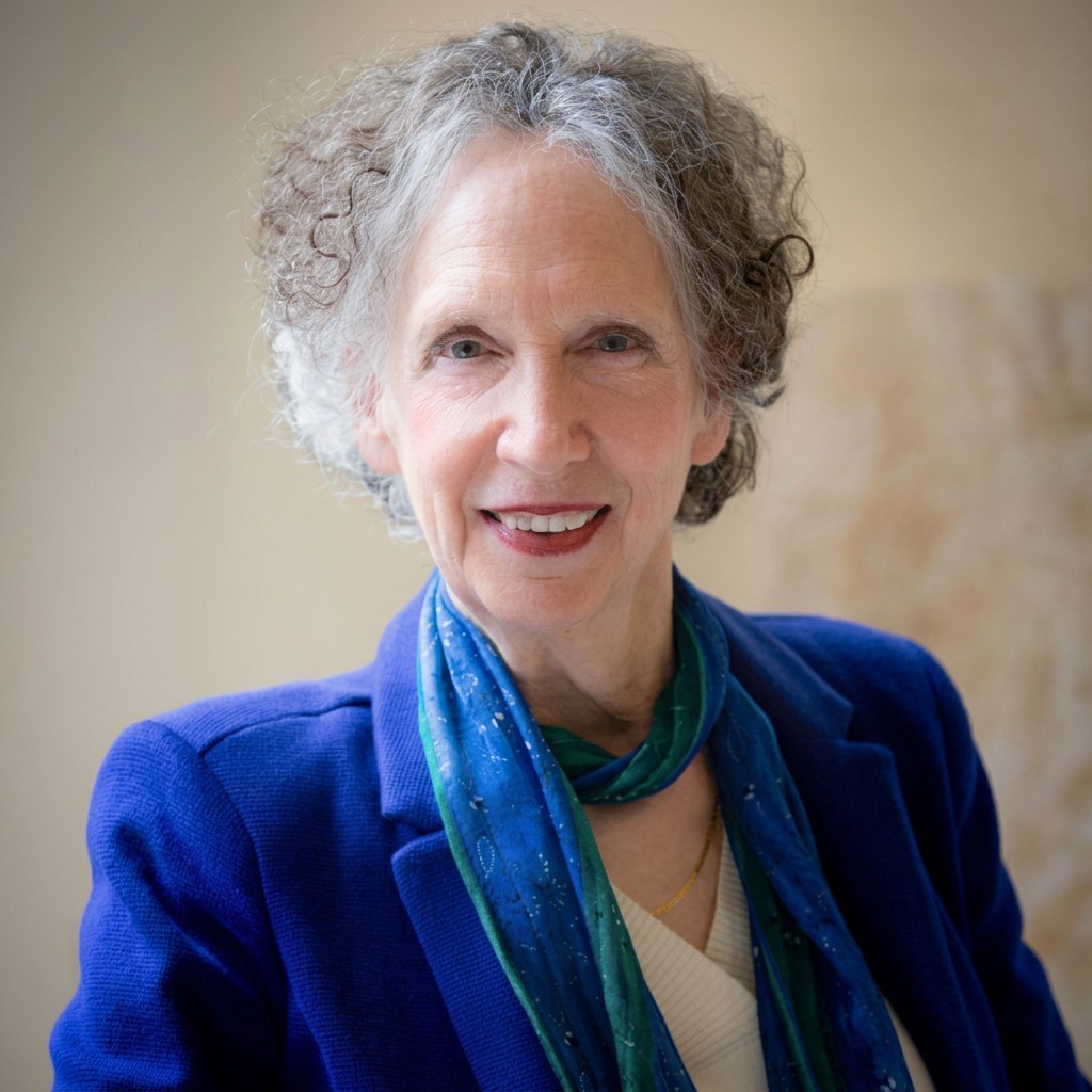 Betsy Polatin wearing a blue jacket and teal scarf